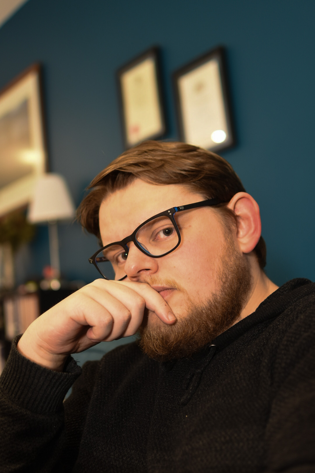 Photo of a man with a beard, wearing glasses